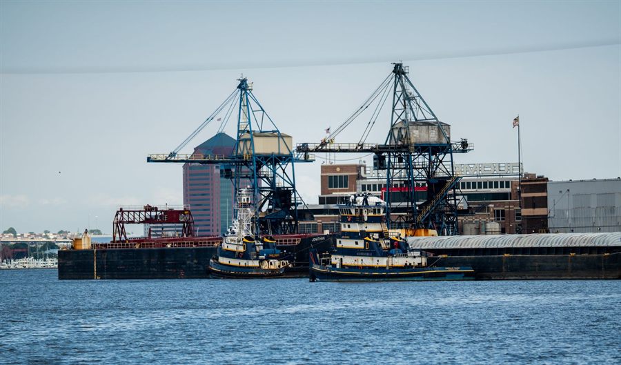 Cranes and tugboats in the Port of Baltimore