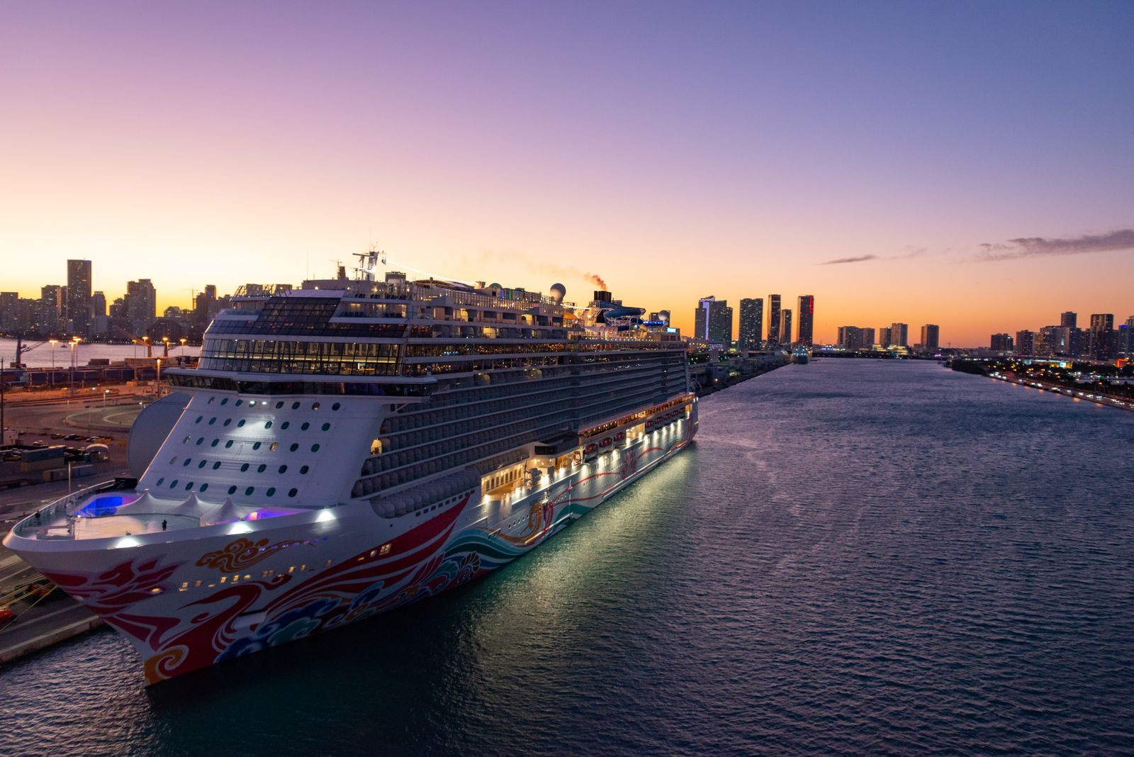 Cruise ship docked at sunset with the Miami skyline, at one of the busiest cruise ports in the US