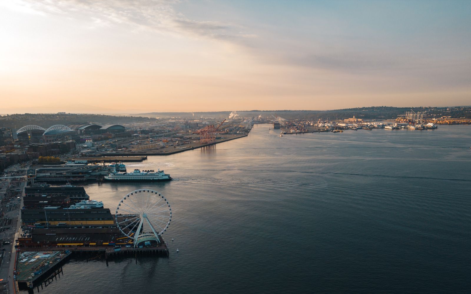 Aerial view of the Seattle waterfront and piers at sunset, one of the cruise ports in the US